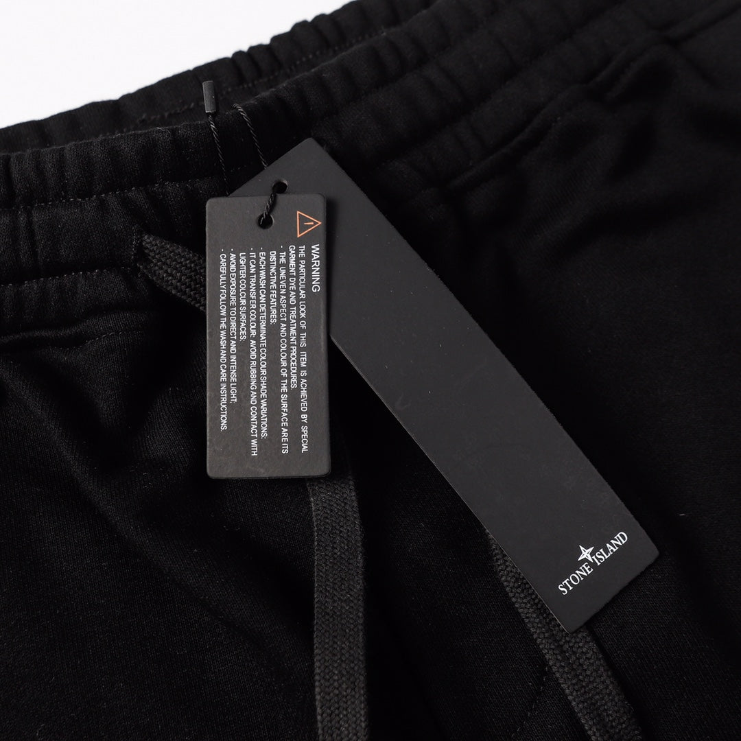 Black shorts with internal drawstring and hanging tag at waistband