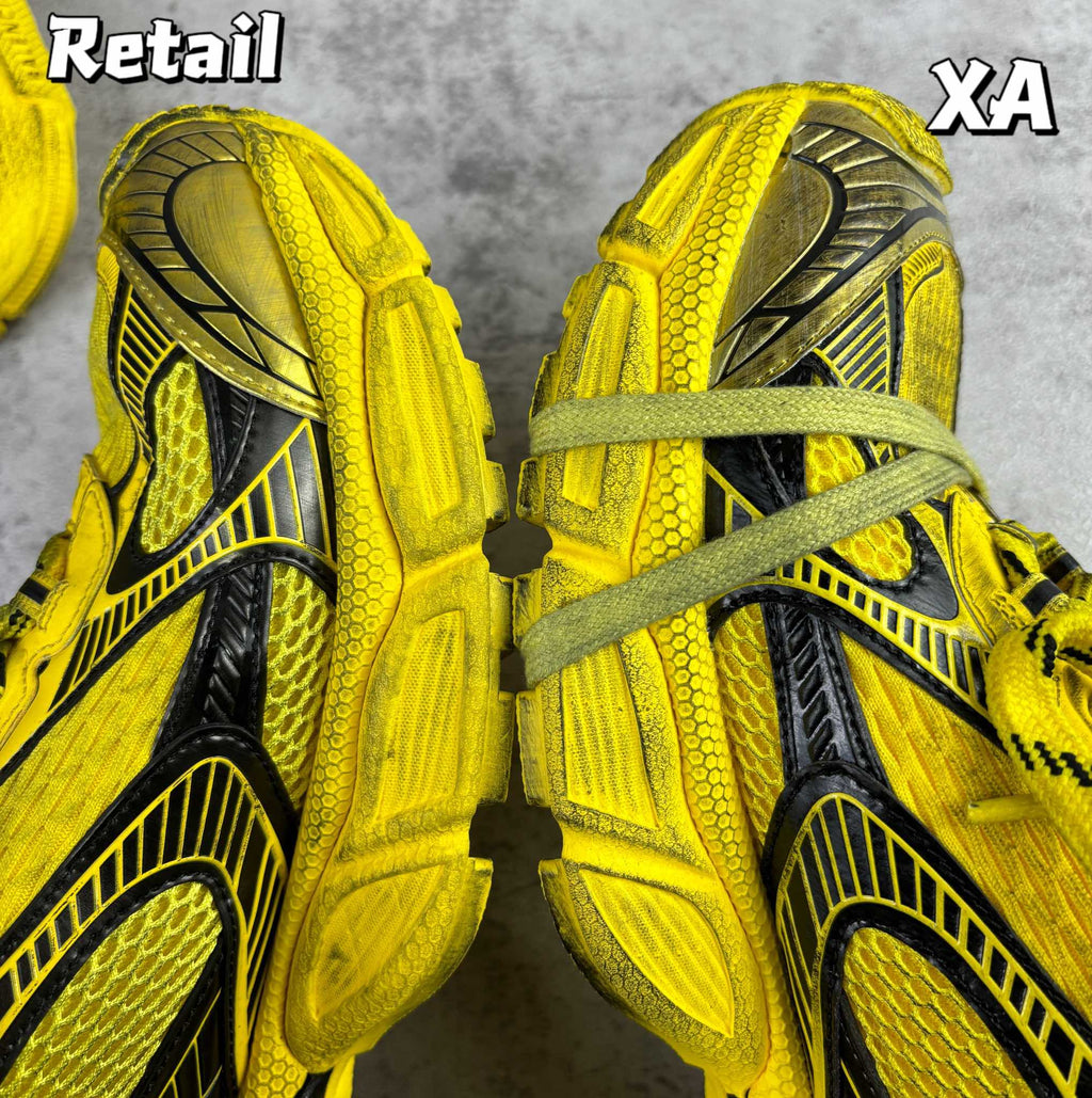 Balenciaga unisex yellow sneakers, close-up top view with laces and black side panels