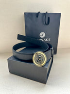 Dark blue leather belt with circular gold logo buckle