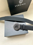 Dark blue leather belt with circular silver buckle detail