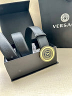 Dark blue leather belt with circular gold logo buckle