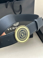 Versace belt close-up: dark blue leather with circular gold-tone logo buckle