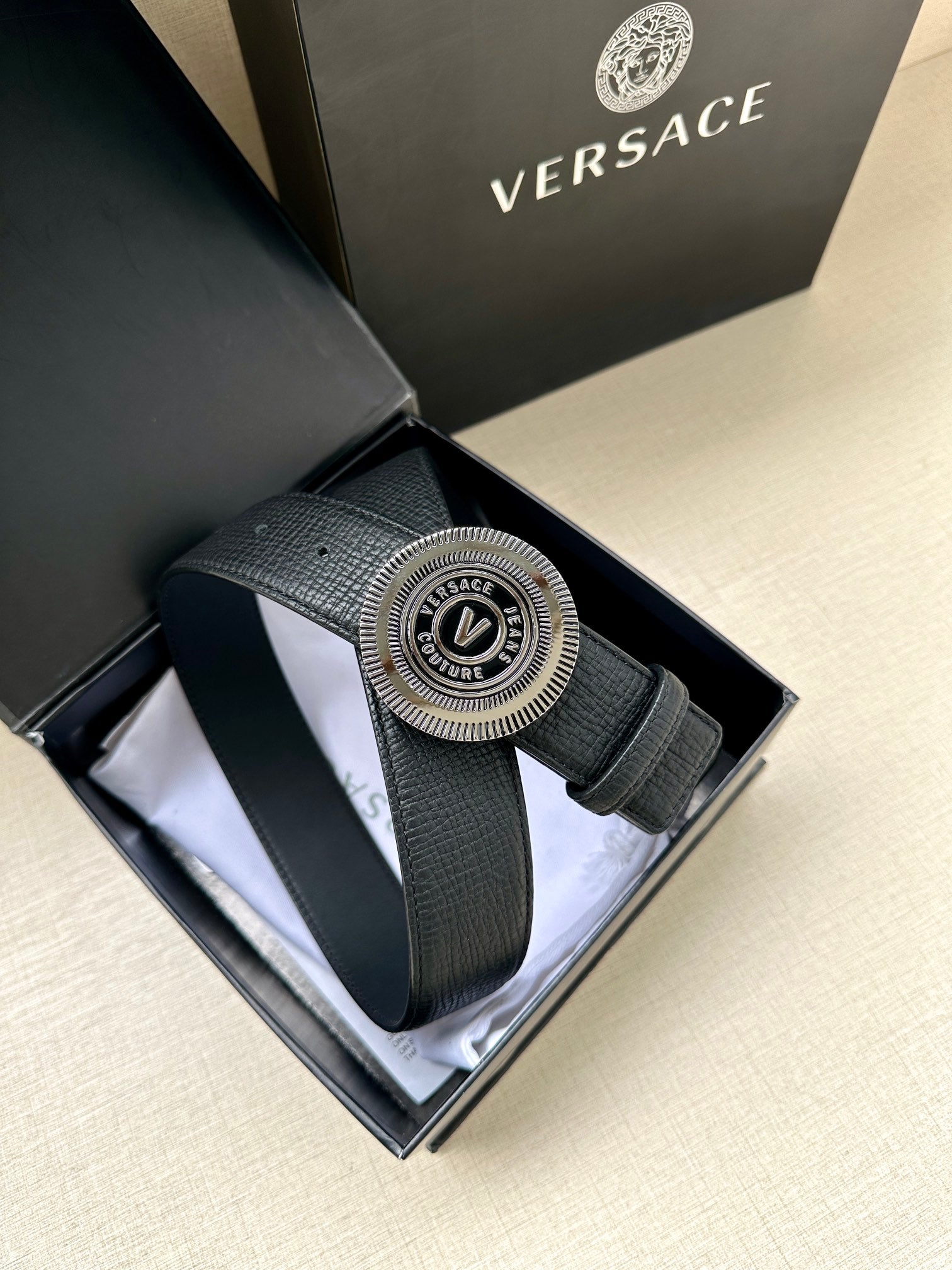 Versace belt with dark blue textured leather and round gold-tone logo buckle