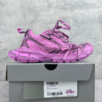 Pink Balenciaga lace-up sneakers with black detailing and chunky tread sole on box