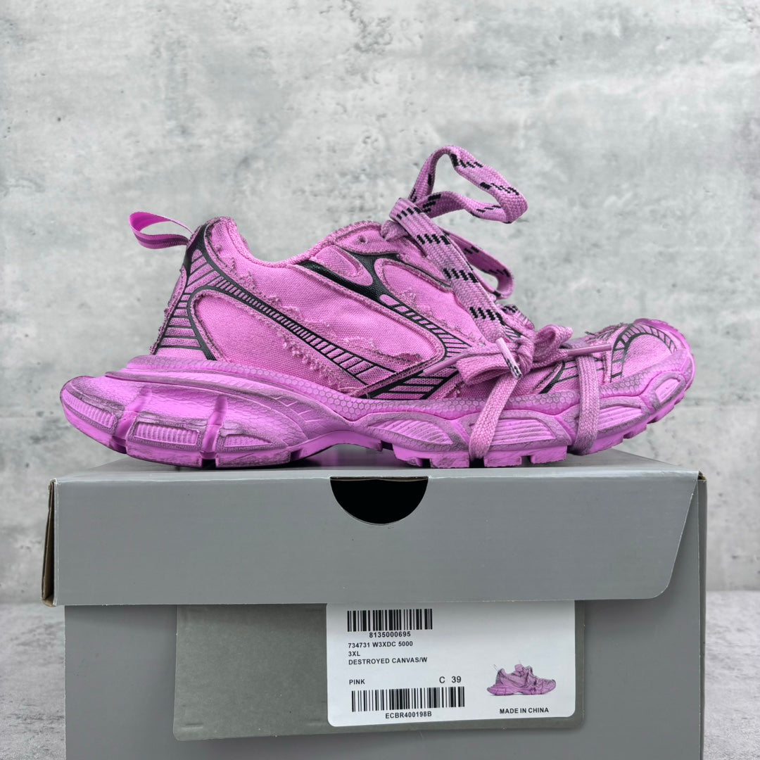 Pink Balenciaga lace-up sneakers with black detailing and chunky tread sole on box