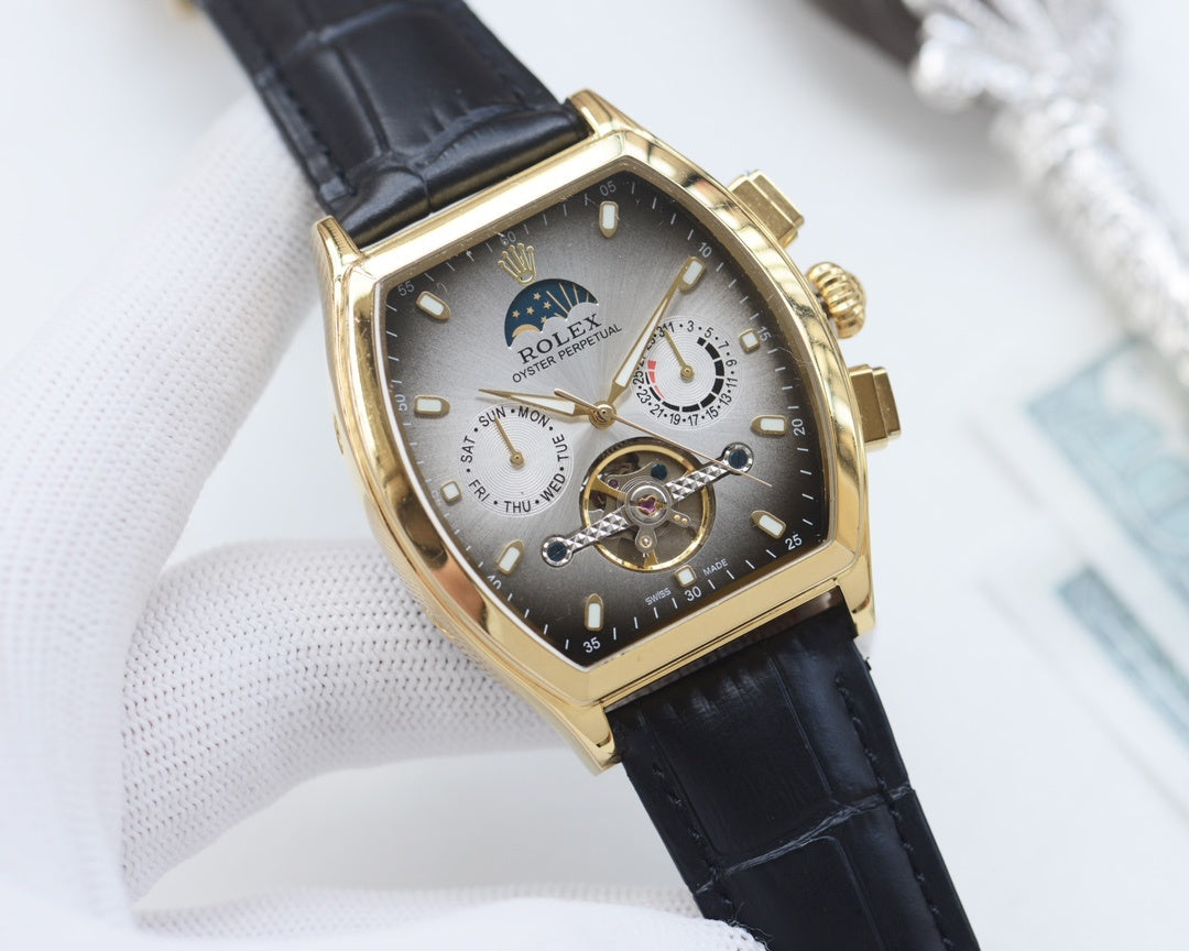 Rolex watch with champagne dial and black leather strap, gold-tone tonneau case