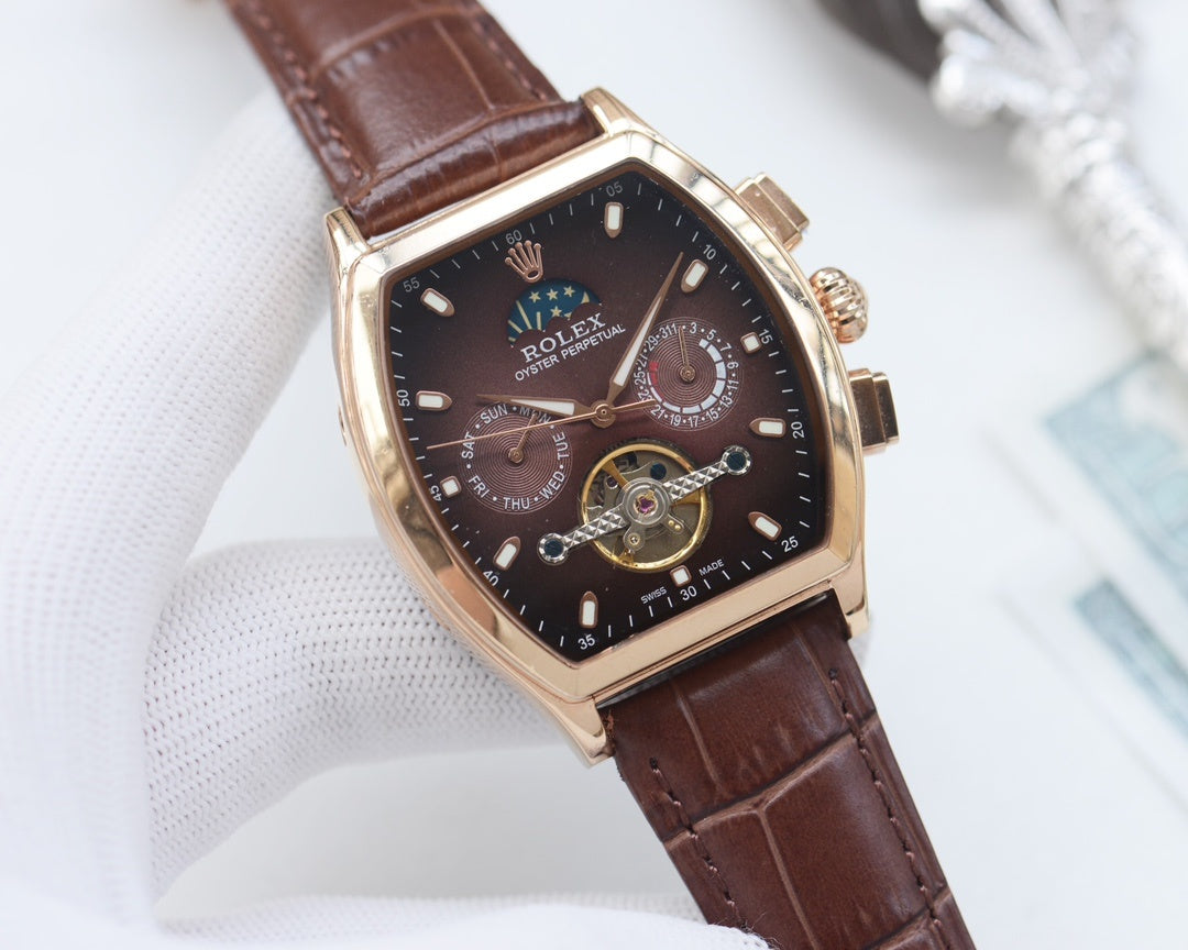 Rolex watch with dark dial and brown leather strap, rose-gold tone tonneau case