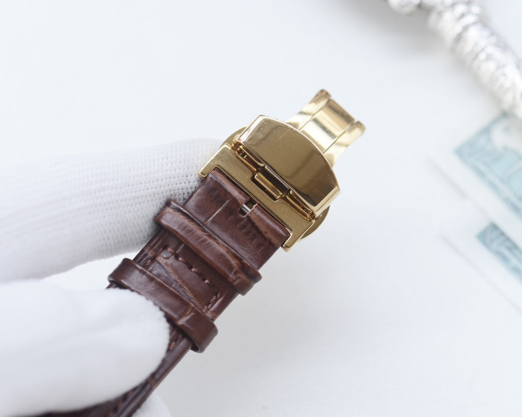 Rolex leather watch strap with gold-tone buckle clasp, attached to watch case