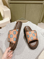Brown slide sandals with multicolor patterned strap and visible side sole