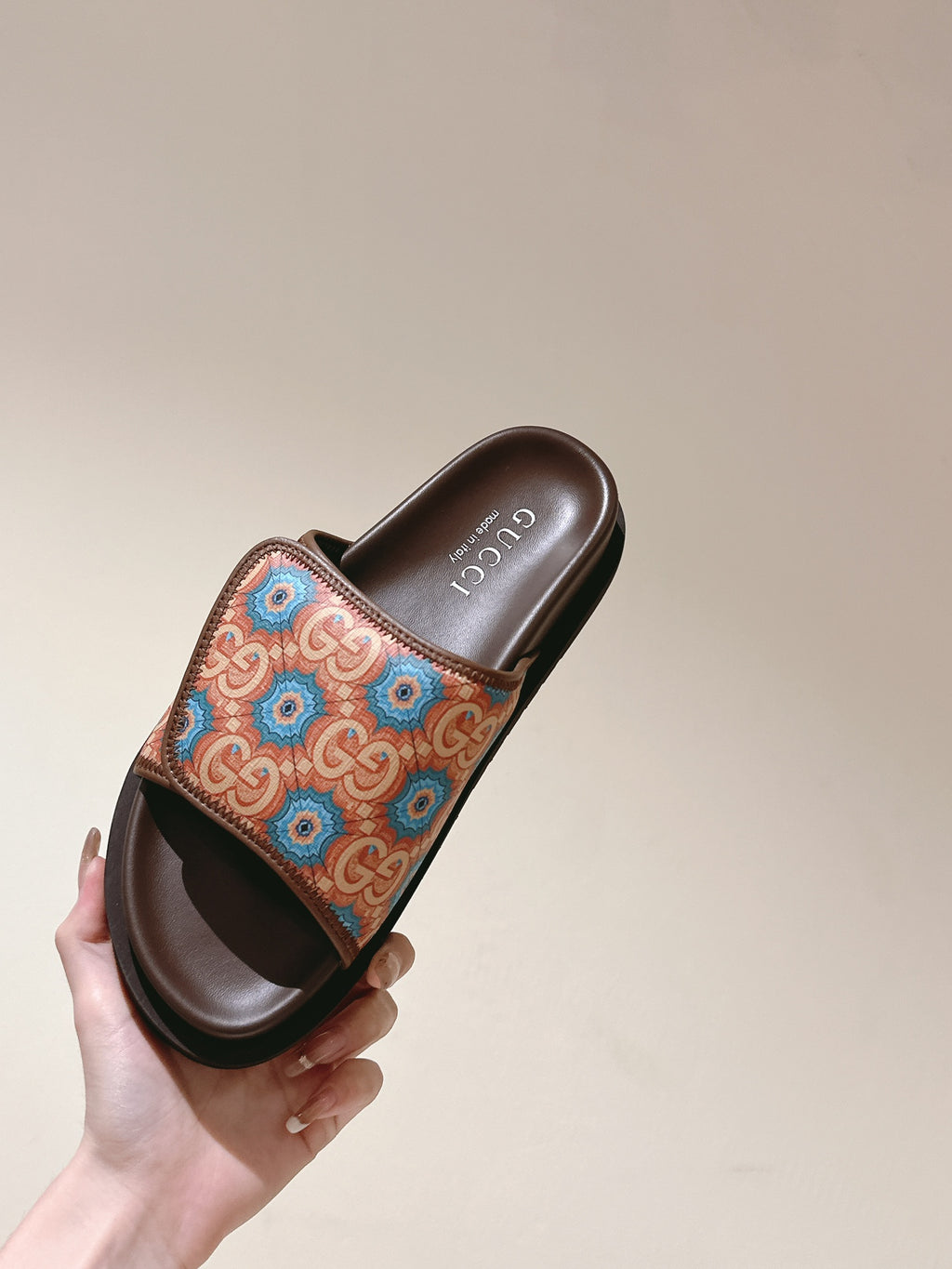 Held brown slide sandal with multicolor patterned strap and open toe