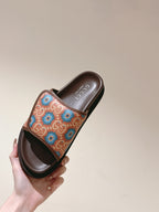 Held brown slide sandal with multicolor patterned strap and open toe