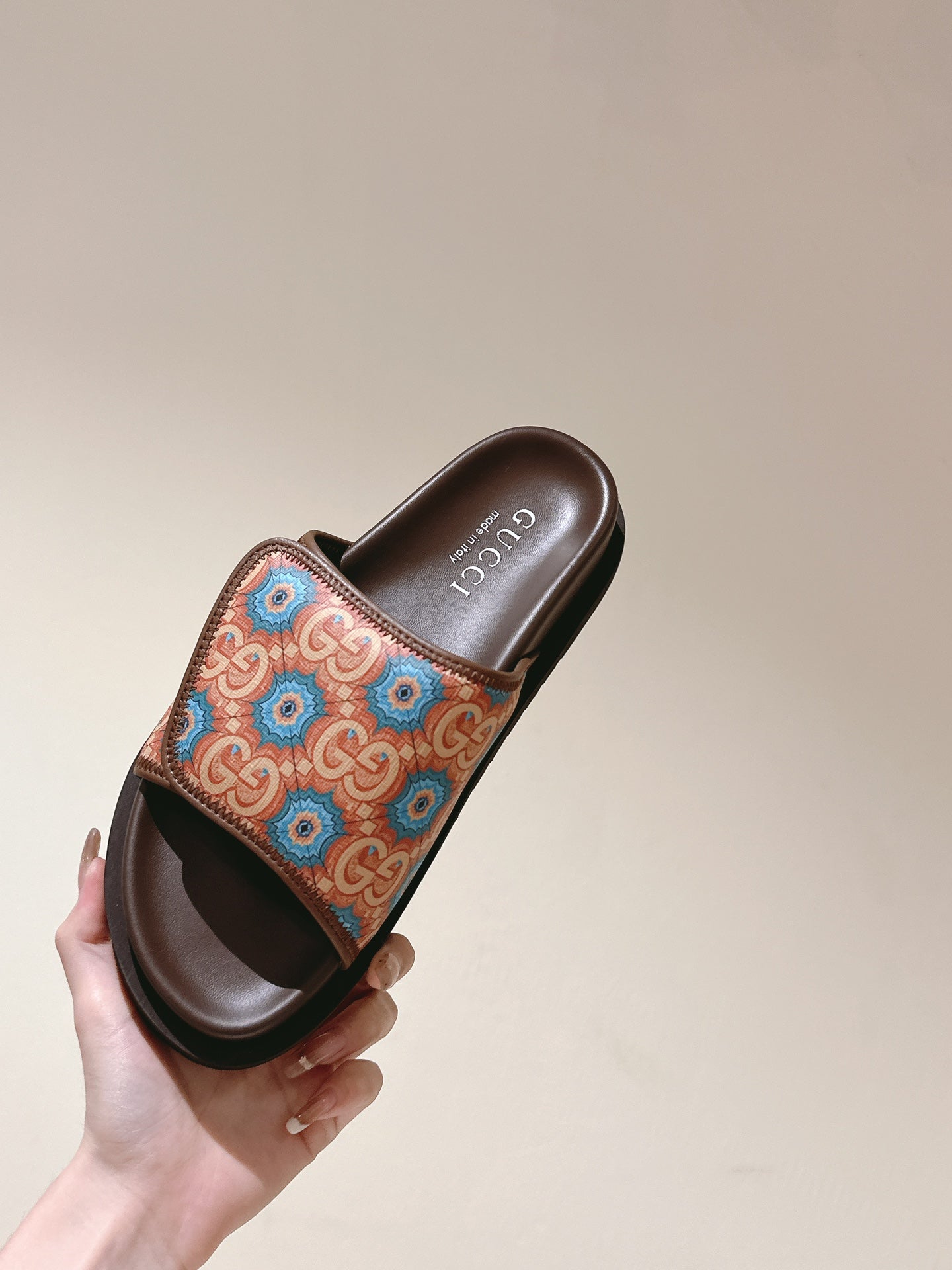 Held brown slide sandal with multicolor patterned strap and open toe