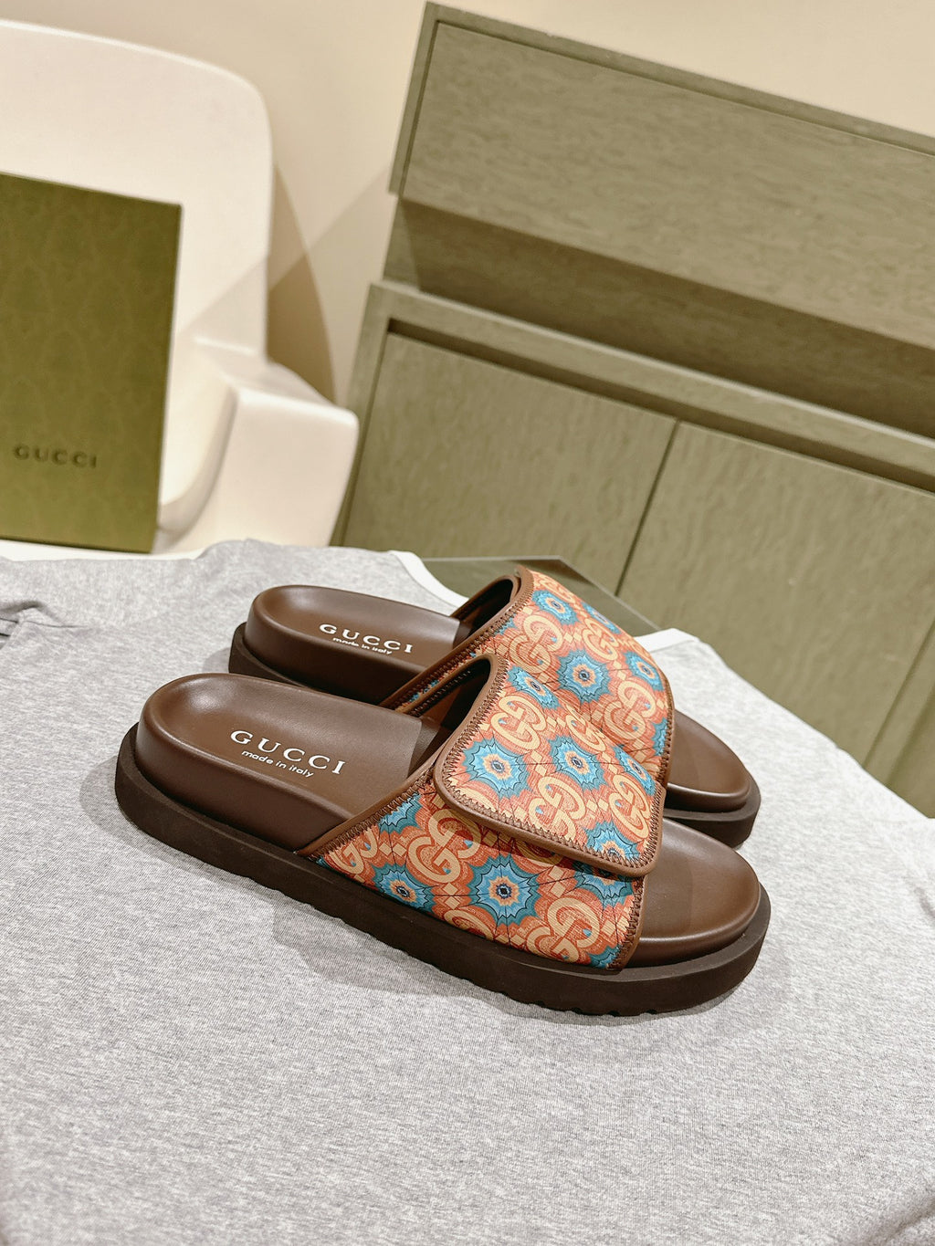 Brown Gucci slide sandals with multicolor ornamental logo-style strap