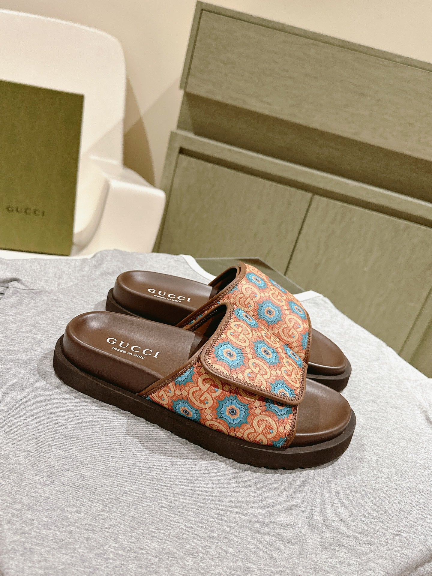 Brown Gucci slide sandals with multicolor ornamental logo-style strap