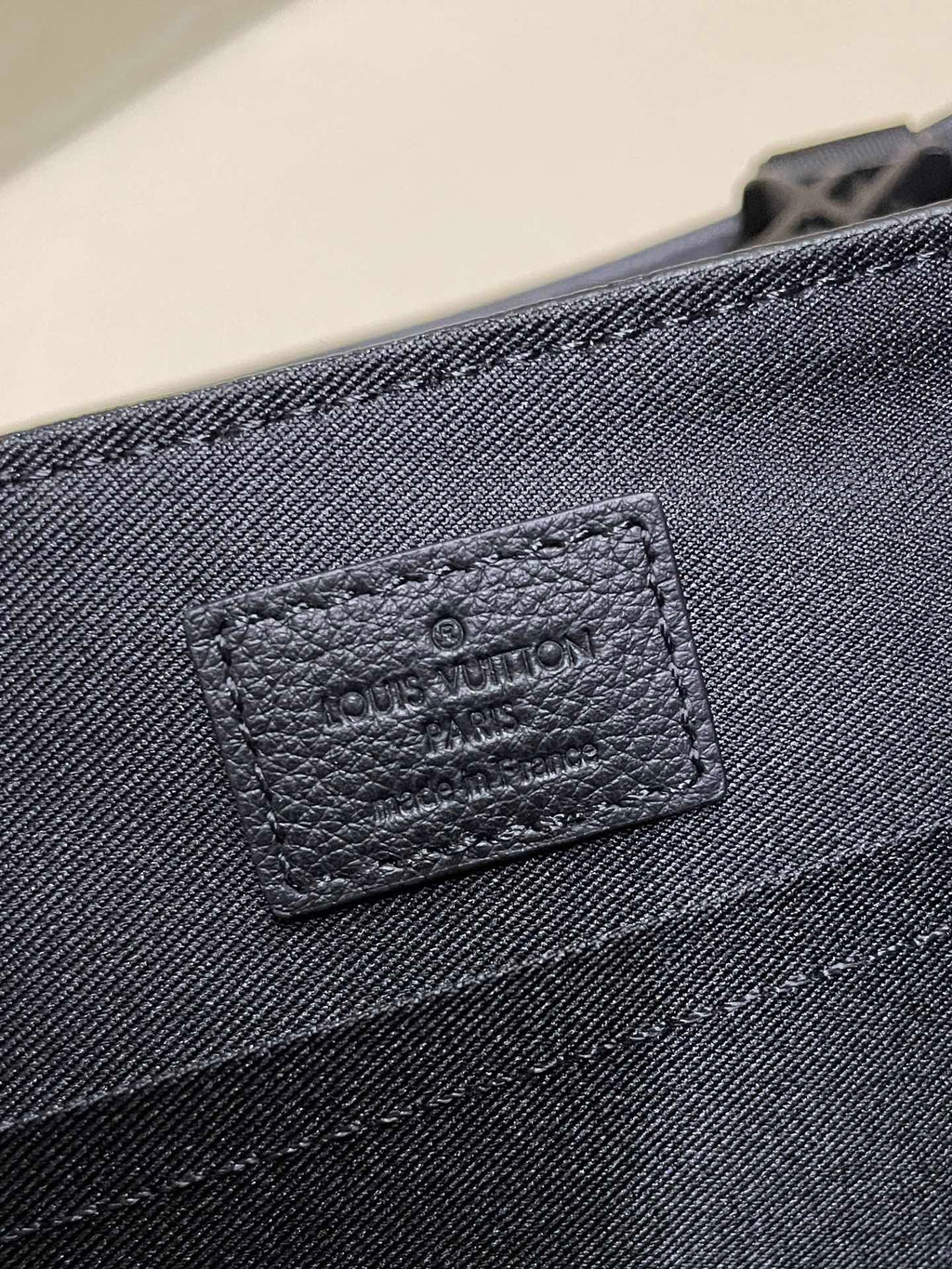 Black monogram leather bag with stitched interior label