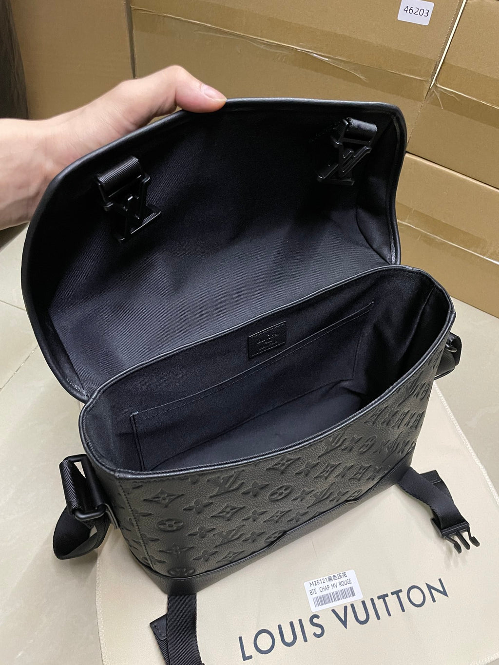 Louis Vuitton men's bag open interior with black lining and top flap hardware