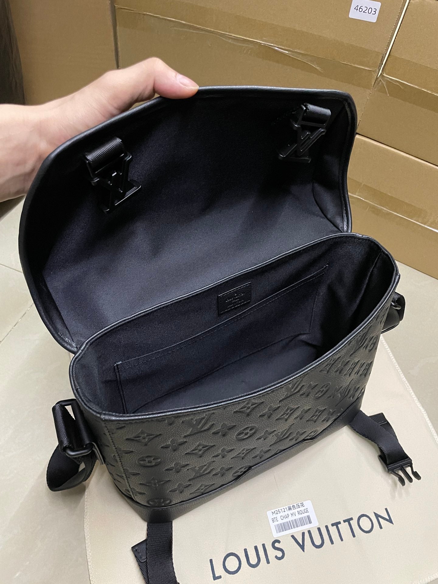 Louis Vuitton men's bag open interior with black lining and top flap hardware
