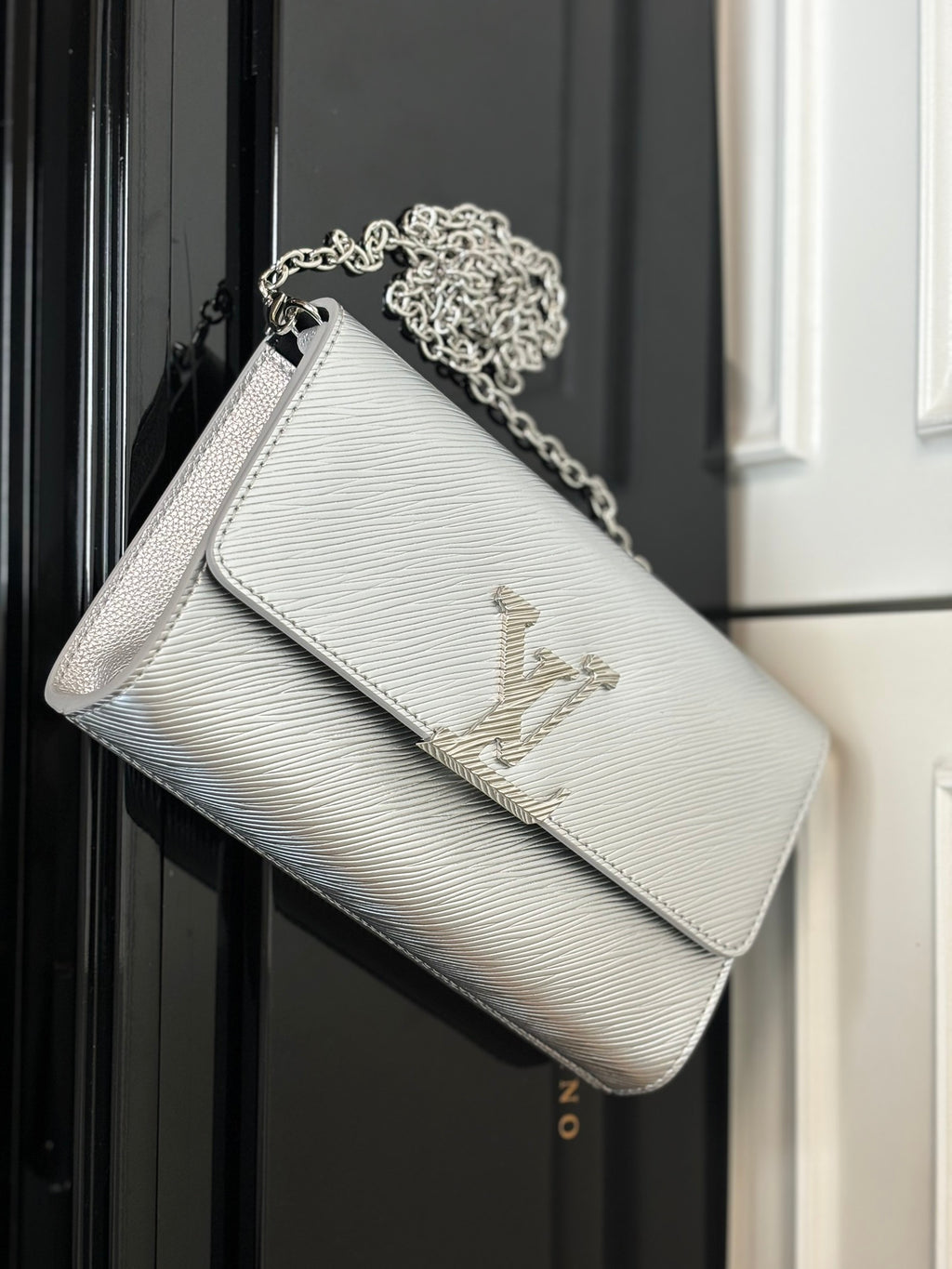 Louis Vuitton crossbody bag in silver-gray with chain strap and LV monogram on front