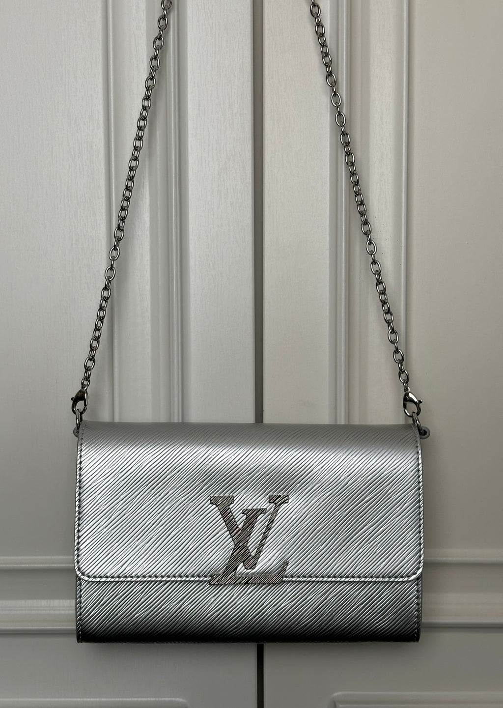 Louis Vuitton small crossbody bag in silver-gray with chain strap and LV logo flap
