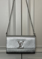 Louis Vuitton small crossbody bag in silver-gray with chain strap and LV logo flap