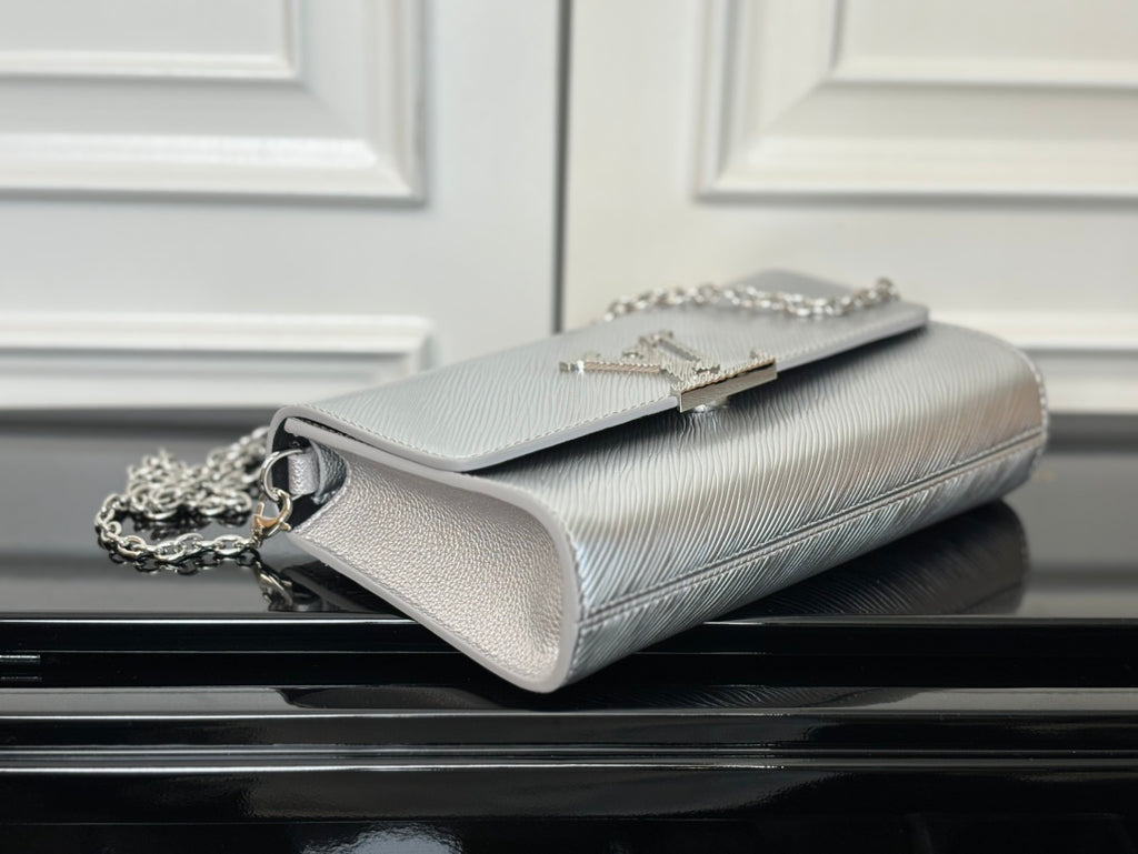 Louis Vuitton shoulder bag in silver-gray with chain strap and hinged flap detail