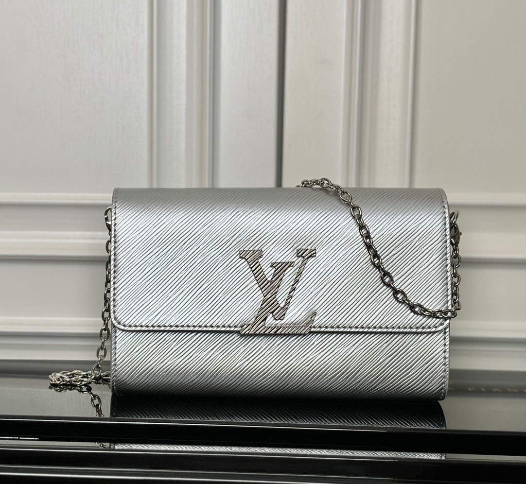 Louis Vuitton crossbody bag in silver-gray with LV logo and chain strap, flap front