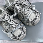Balenciaga unisex sneakers close-up showing silver mesh panels and laces