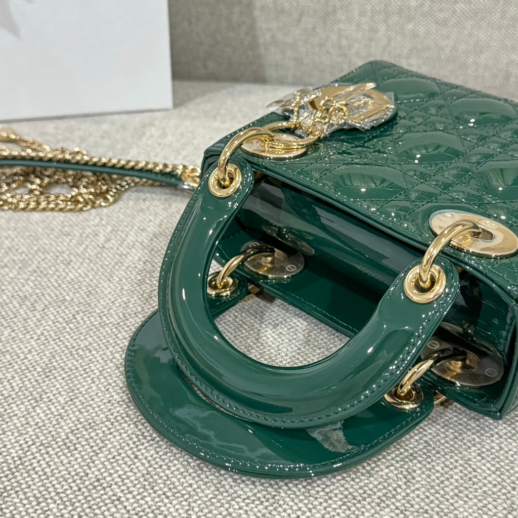 Green Dior handbag with side hardware, top handle loops, and gold-tone chain