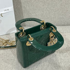 Green Dior handbag on chain with top handles, gold-tone hardware, and charm