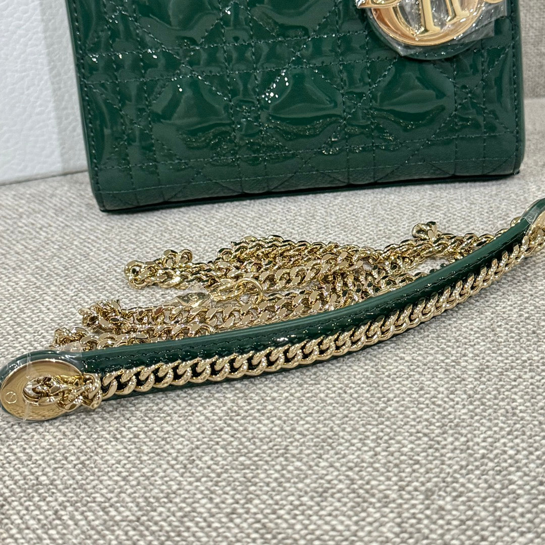 Green Dior handbag bottom edge with gold-tone chain and quilted front panel