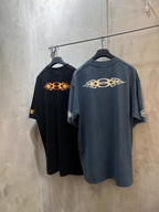 Black and blue Balenciaga T-shirts with orange flame logo, hanging together