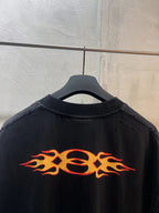 Black Balenciaga T-shirt back with large orange flame graphic across shoulders
