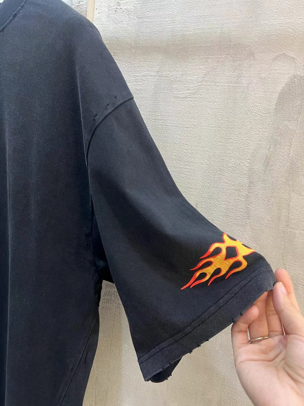 Black Balenciaga T-shirt sleeve with orange flame graphic