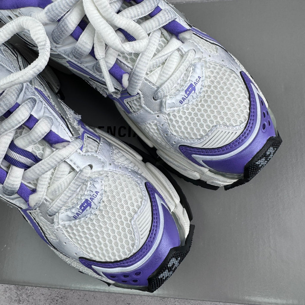 Unisex runner sneakers close-up, white mesh with purple trims and BALENCIAGA branding