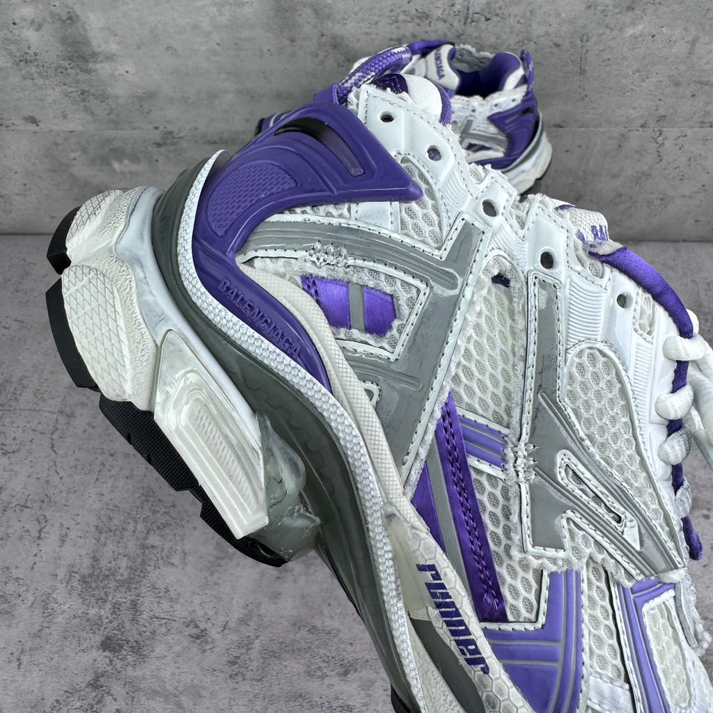 Unisex runner sneakers angled view, white upper with bold purple overlays and laces