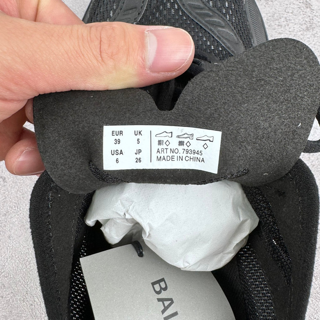 Size label inside dark sneaker with EUR 39 and UK 5.5; made in China