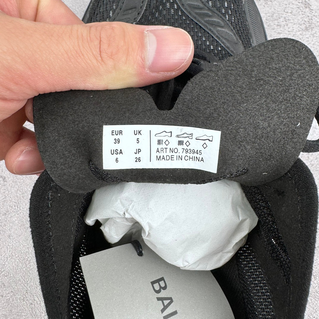 Size label inside dark sneaker with EUR 39 and UK 5.5; made in China