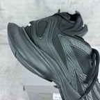 Dark gray/black unisex sneaker with padded heel, perforated panels, and thick tread sole
