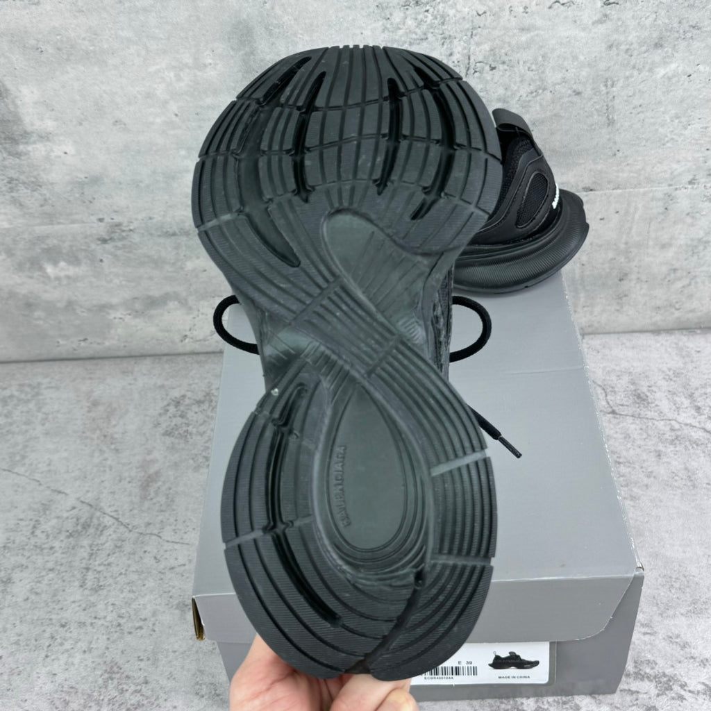 Dark gray/black sneaker outsole with lug tread and sidewall cushioning
