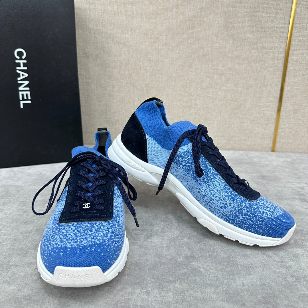 Unisex blue knit sneakers pair with dark navy laces, black side panels, white soles