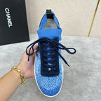 Unisex blue knit sneakers showing front, dark navy laces, black logo patch, white sole