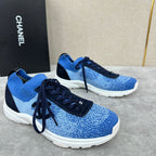 Unisex blue knit sneakers with dark navy laces, black side panel, and white sole