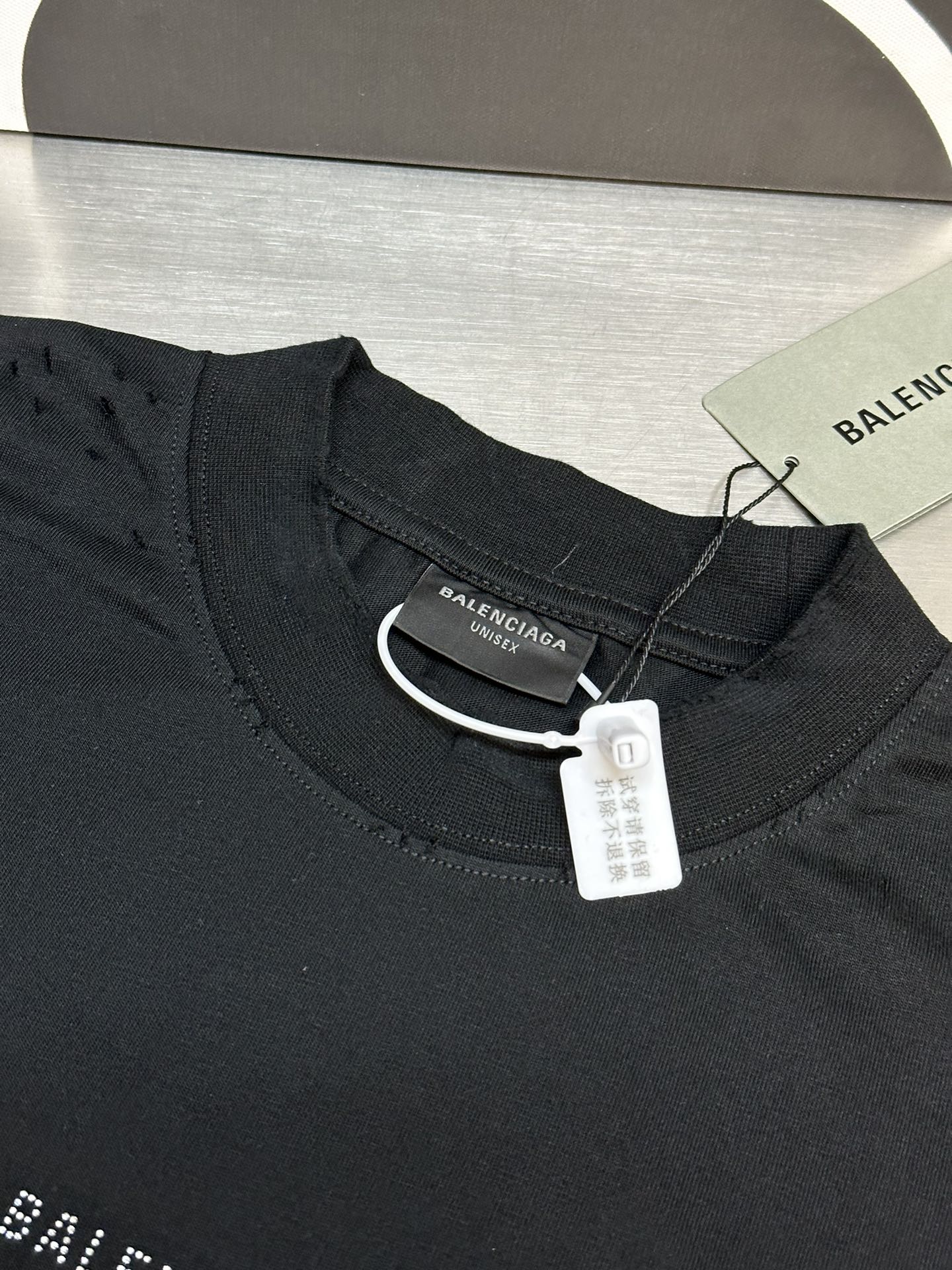 Balenciaga black T-shirt neckline with fabric label tag