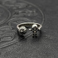Silver-tone ring with skull head and flower emblem