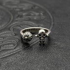 Silver-tone ring with skull head and flower emblem