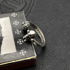 Silver-tone ring with engraved nameplate and skull charm