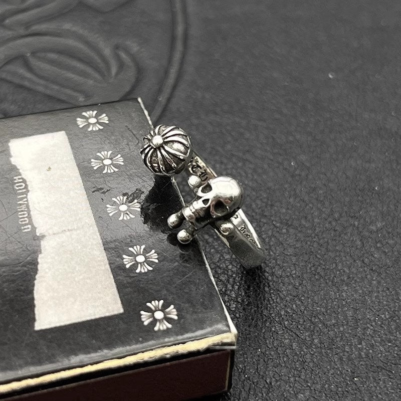 Silver-tone adjustable ring with skull charm and daisy accents