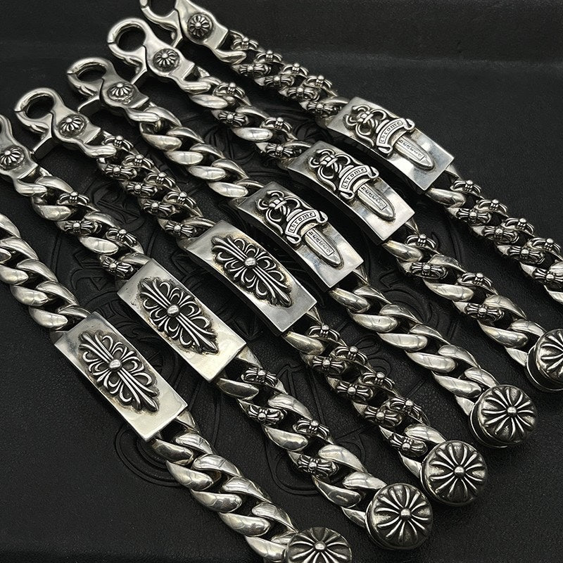 Silver-tone chain bracelet with decorative links and engraved rectangular plates