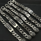 Silver-tone chain bracelet with decorative links and engraved rectangular plates