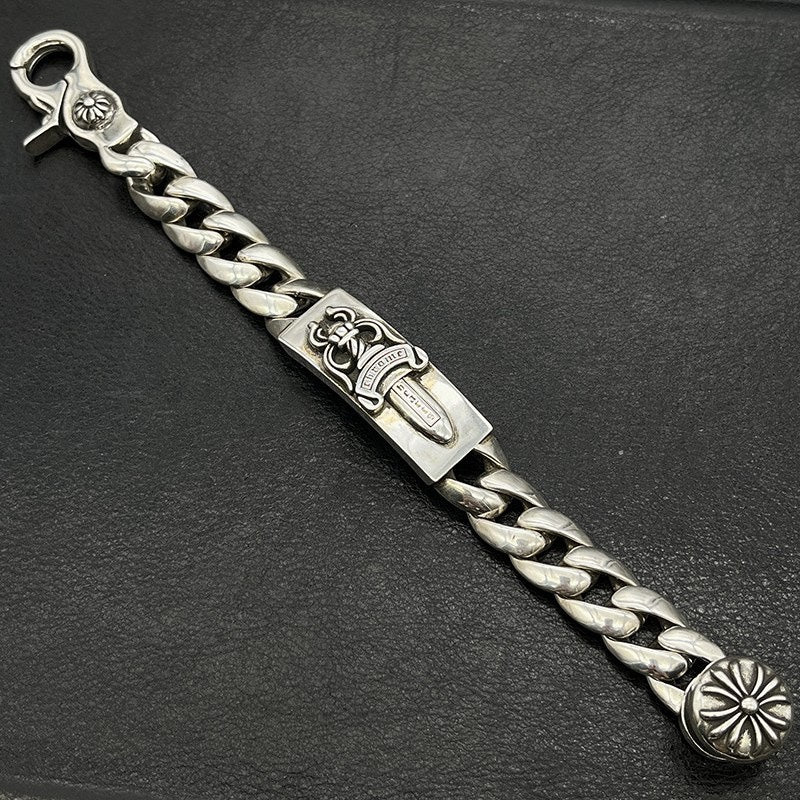 Silver-tone chain bracelet with engraved rectangular plate, braided links, and flower end cap